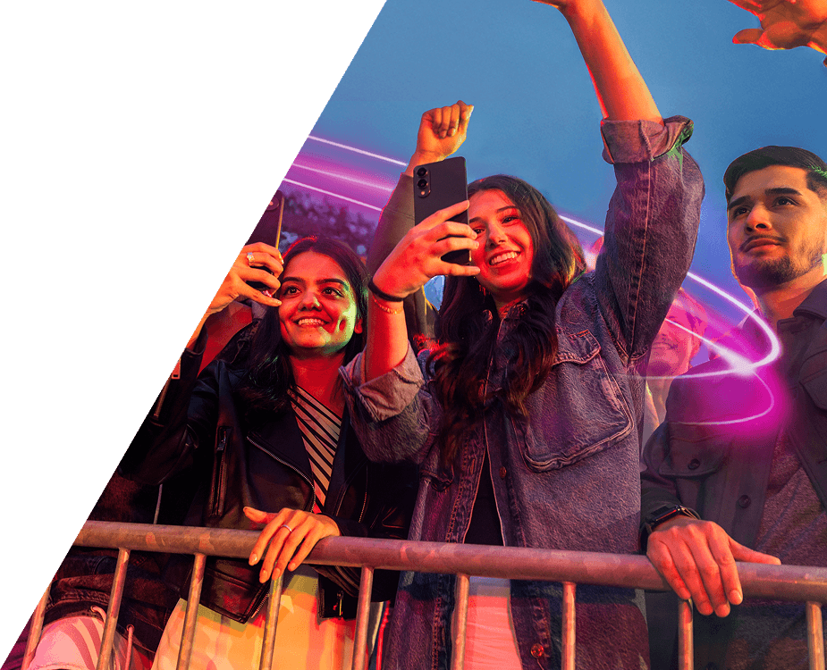 People raising their hands and phones