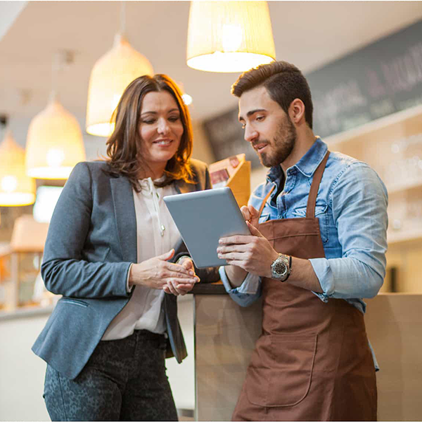 Two people looking at a device